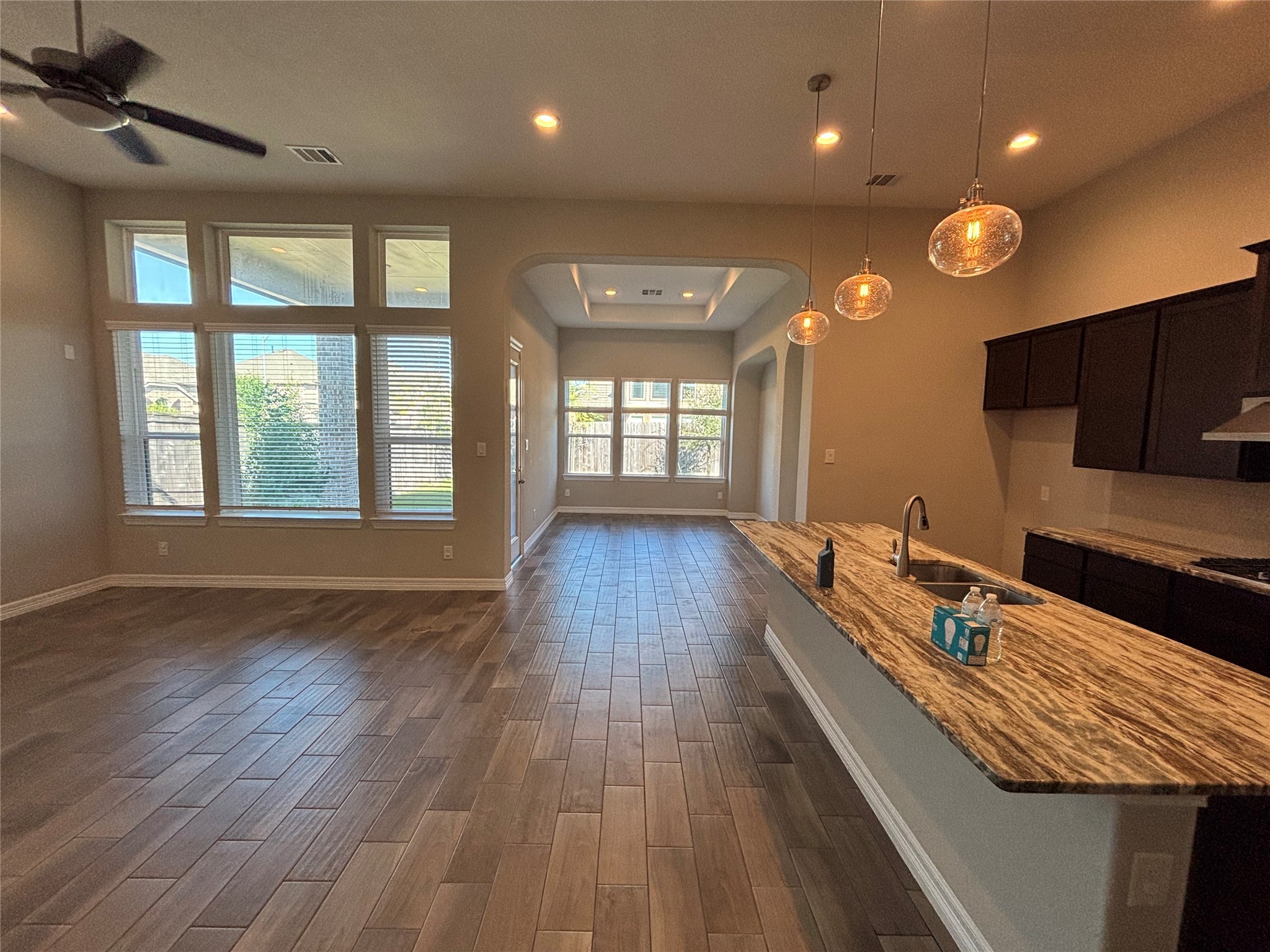 20826 Stonebreak Lane Spring, TX 77379 - Photo 15 of 37 a view of a room with kitchen island wooden floor and windows
