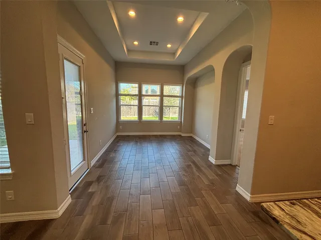 a kitchen with kitchen island granite countertop a refrigerator a sink and a stove