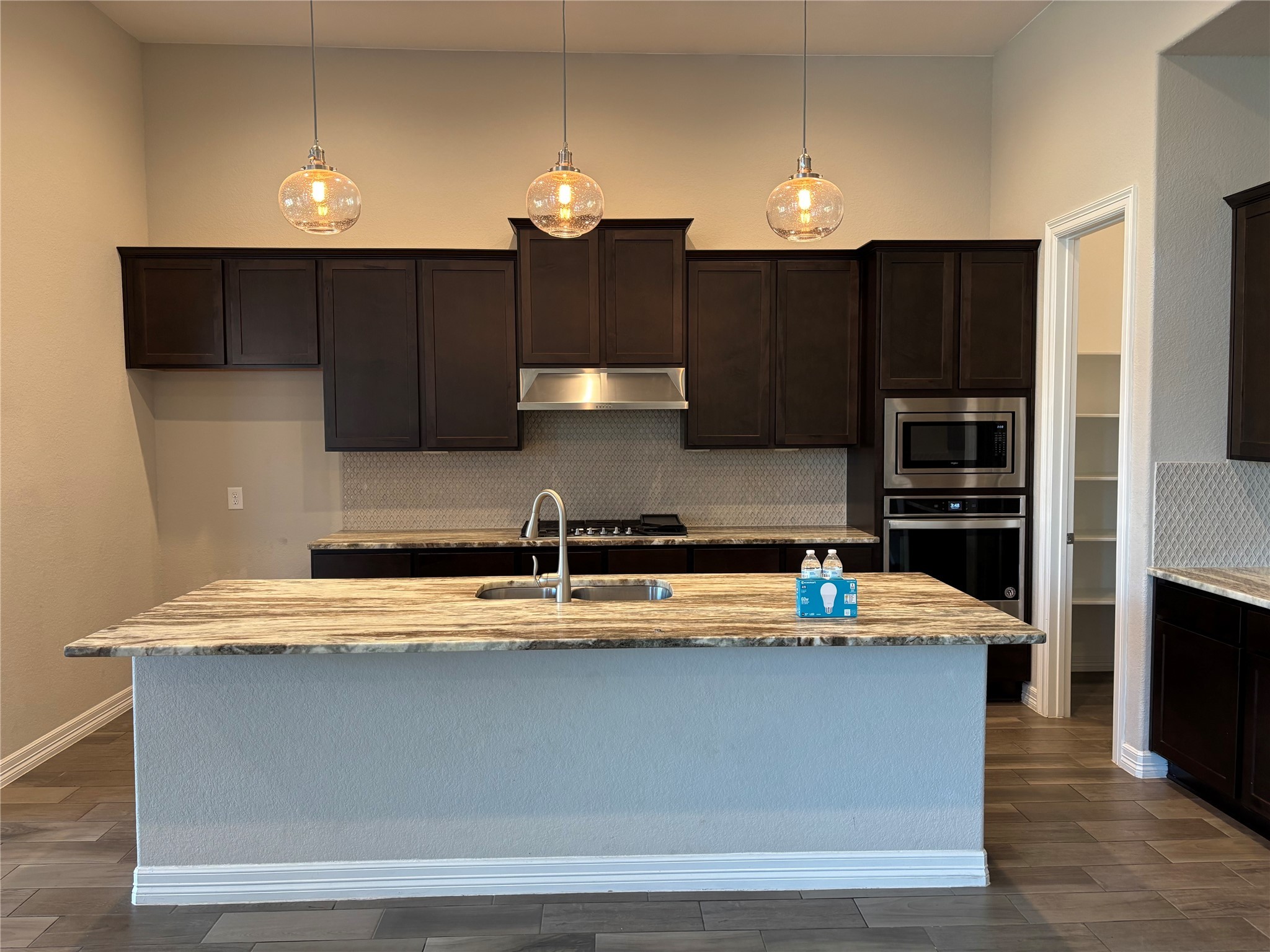 20826 Stonebreak Lane Spring, TX 77379 - Photo 19 of 37 a kitchen with kitchen island granite countertop a refrigerator a sink and a stove