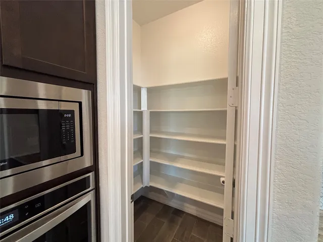 an empty room with fan and windows