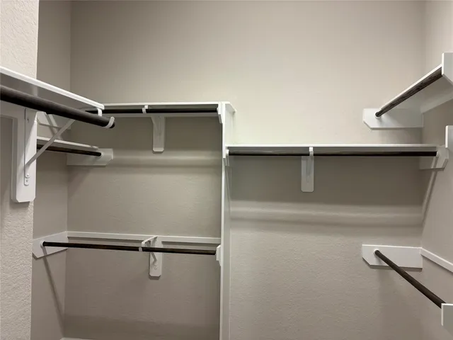 a bathroom with a granite countertop toilet sink and mirror