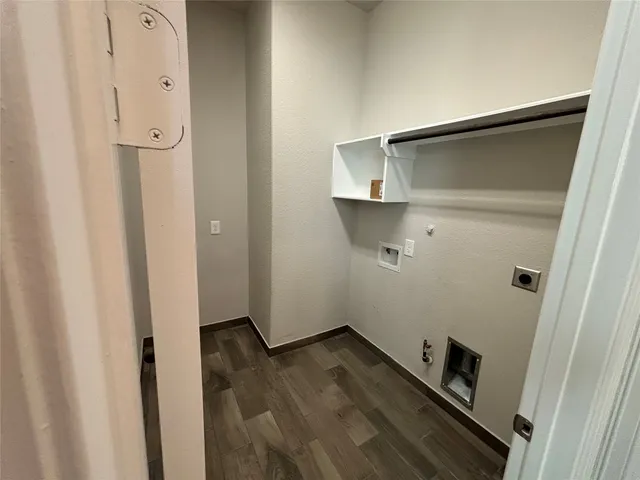 a view of a hallway with wooden floor and closet