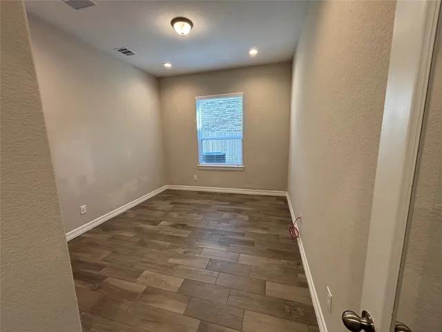 a view of gallery with wooden floor