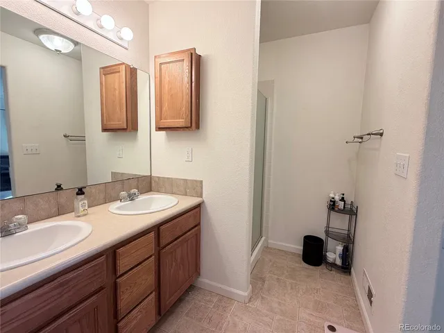 a bathroom with a sink double vanity and a mirror