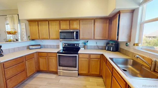 a kitchen with stainless steel appliances granite countertop a sink and a stove