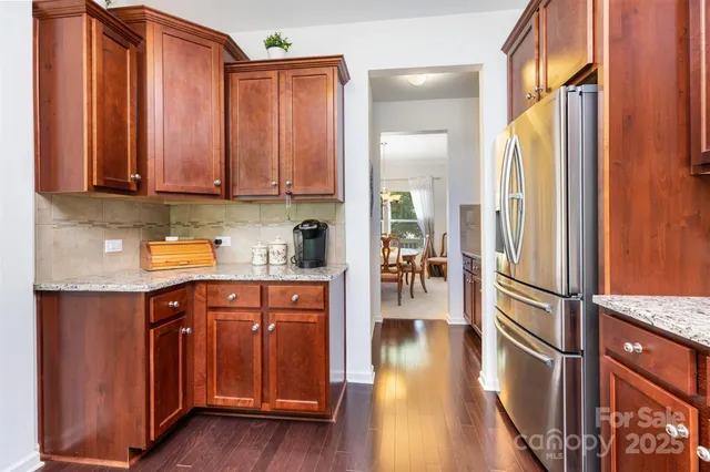 a kitchen with stainless steel appliances granite countertop a refrigerator and a sink