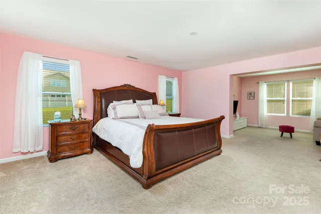 a bed room with a bed and a chair