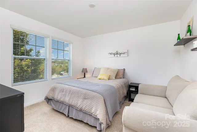 a bedroom with a bed couch and window