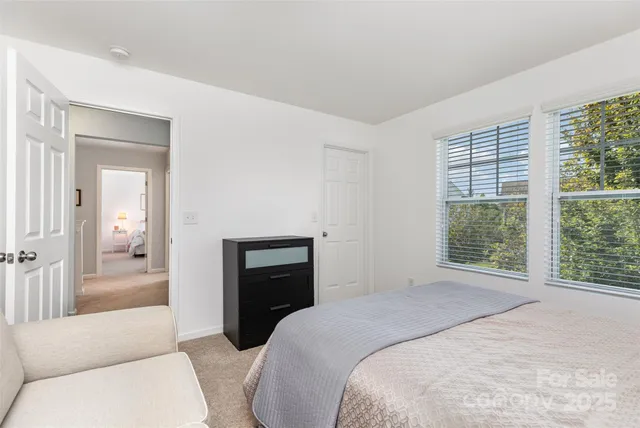 a bedroom with a bed and a couch