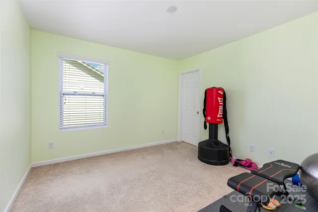a view of a room with gym equipment and a window