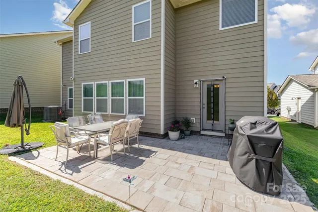 a building outdoor space with patio furniture and swimming pool
