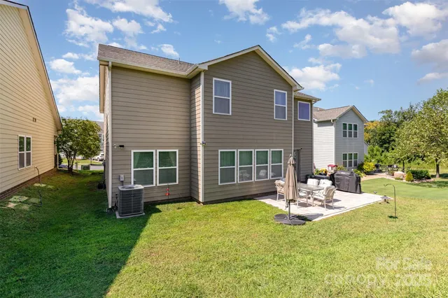 a view of a house with backyard porch and sitting area