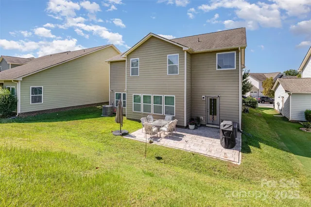 a view of backyard with a patio and a garden