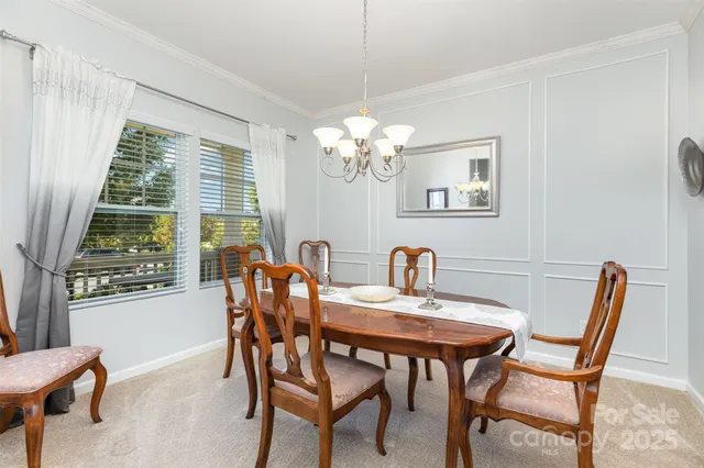 a view of a dining room with furniture and a window