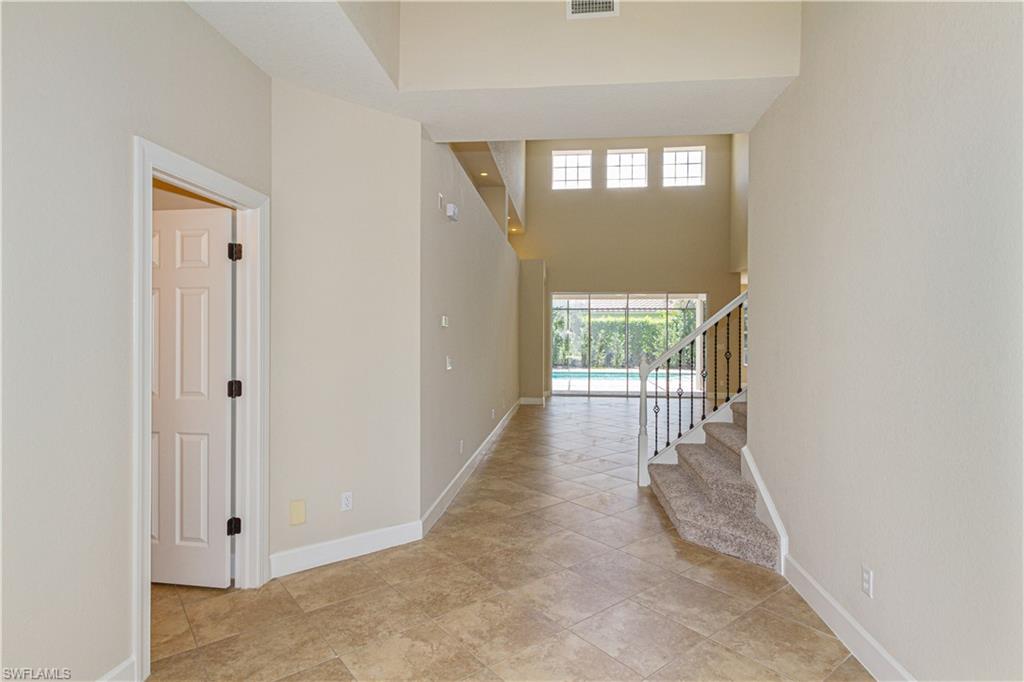 9172 Quartz Lane Naples, FL 34120 - Photo 12 of 25 a view of a hallway with windows