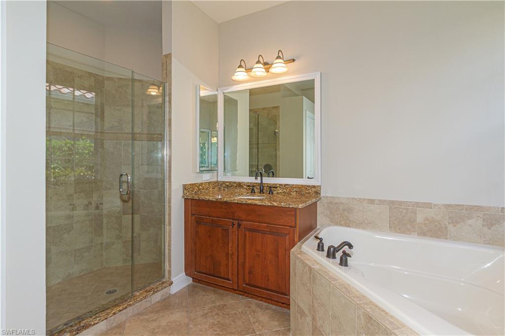 9172 Quartz Lane Naples, FL 34120 - Photo 20 of 25 a bathroom with a tub sink and mirror