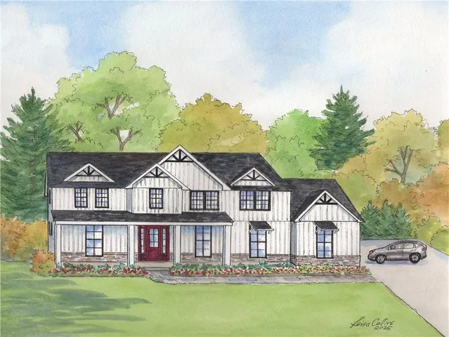 a front view of a house with a garden and lake view