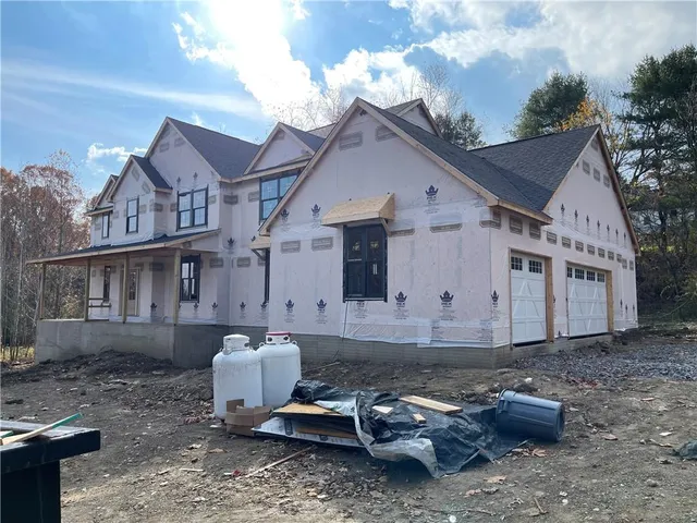 a front view of a house with sitting area