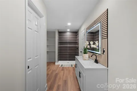 a view of a room with wooden floor and a ceiling fan