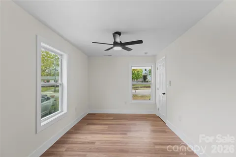 a bathroom with a granite countertop sink a toilet and shower