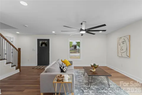 a living room with furniture and a wooden floor