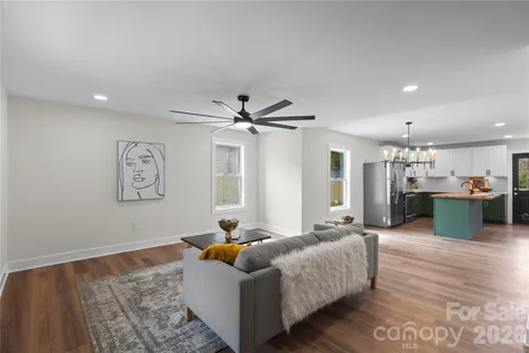a living room with furniture and kitchen view
