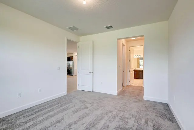 a view of an empty room and closet area