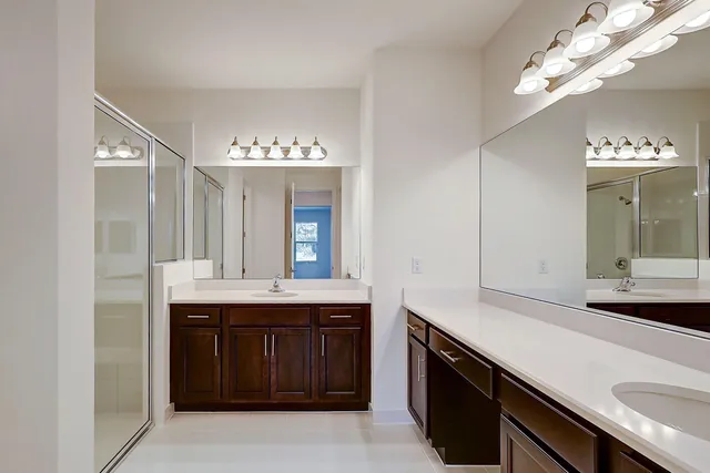a spacious bathroom with a double vanity sink and a mirror