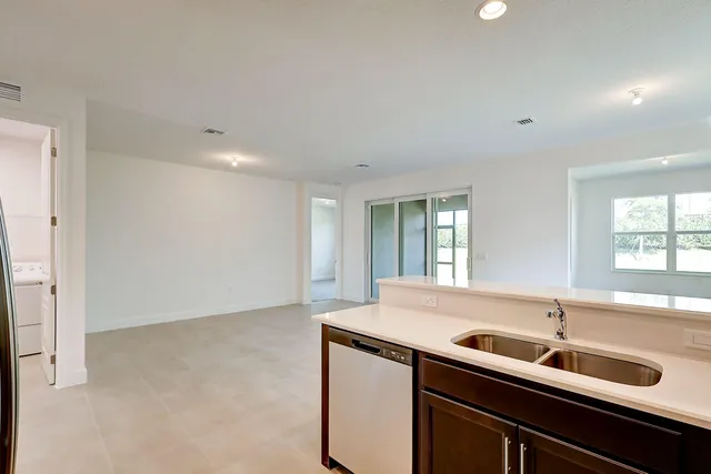 a kitchen with a sink cabinets and window