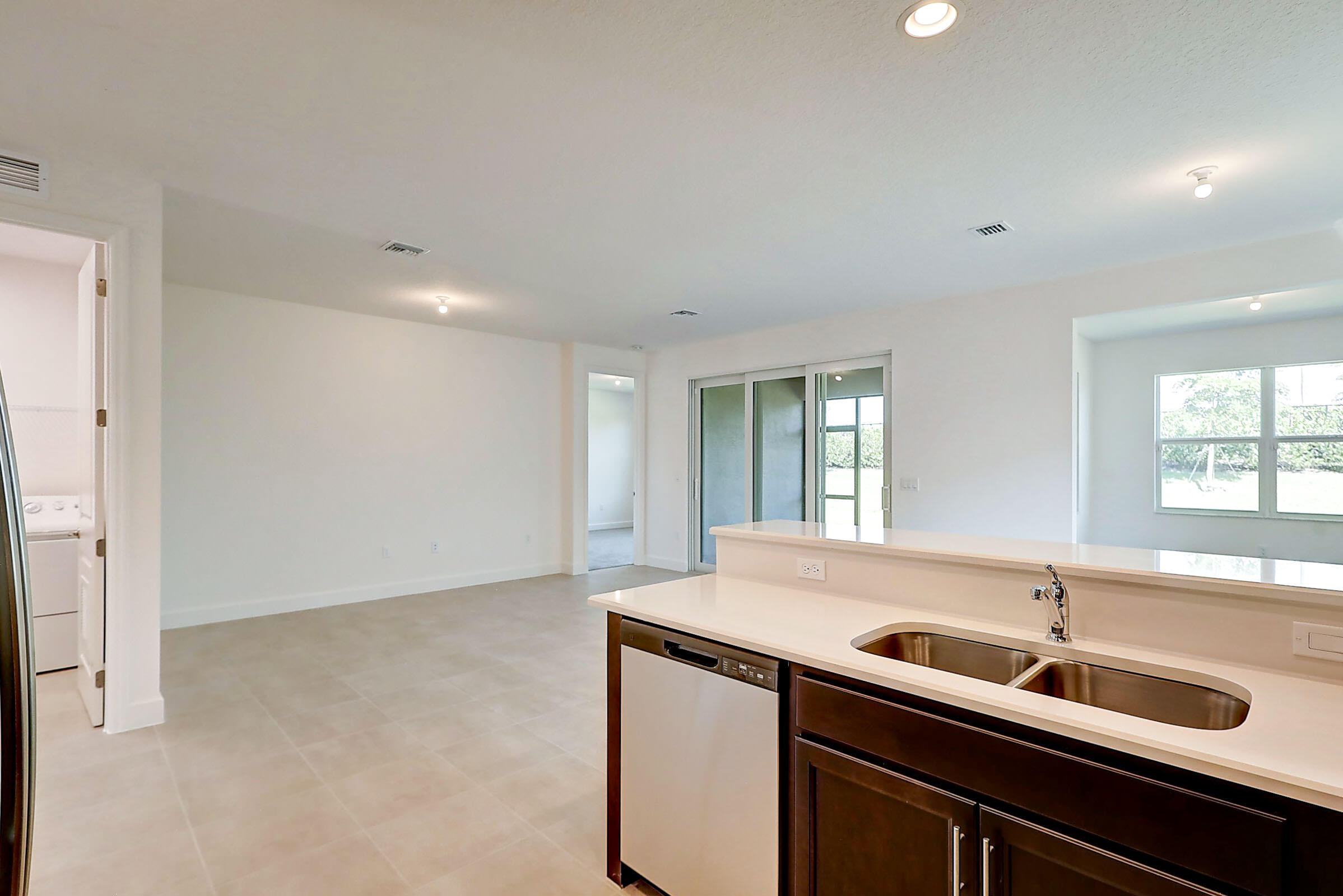 13549 Southwest Oceanus Boulevard Port St. Lucie, FL 34987 - Photo 21 of 30 a kitchen with a sink cabinets and window