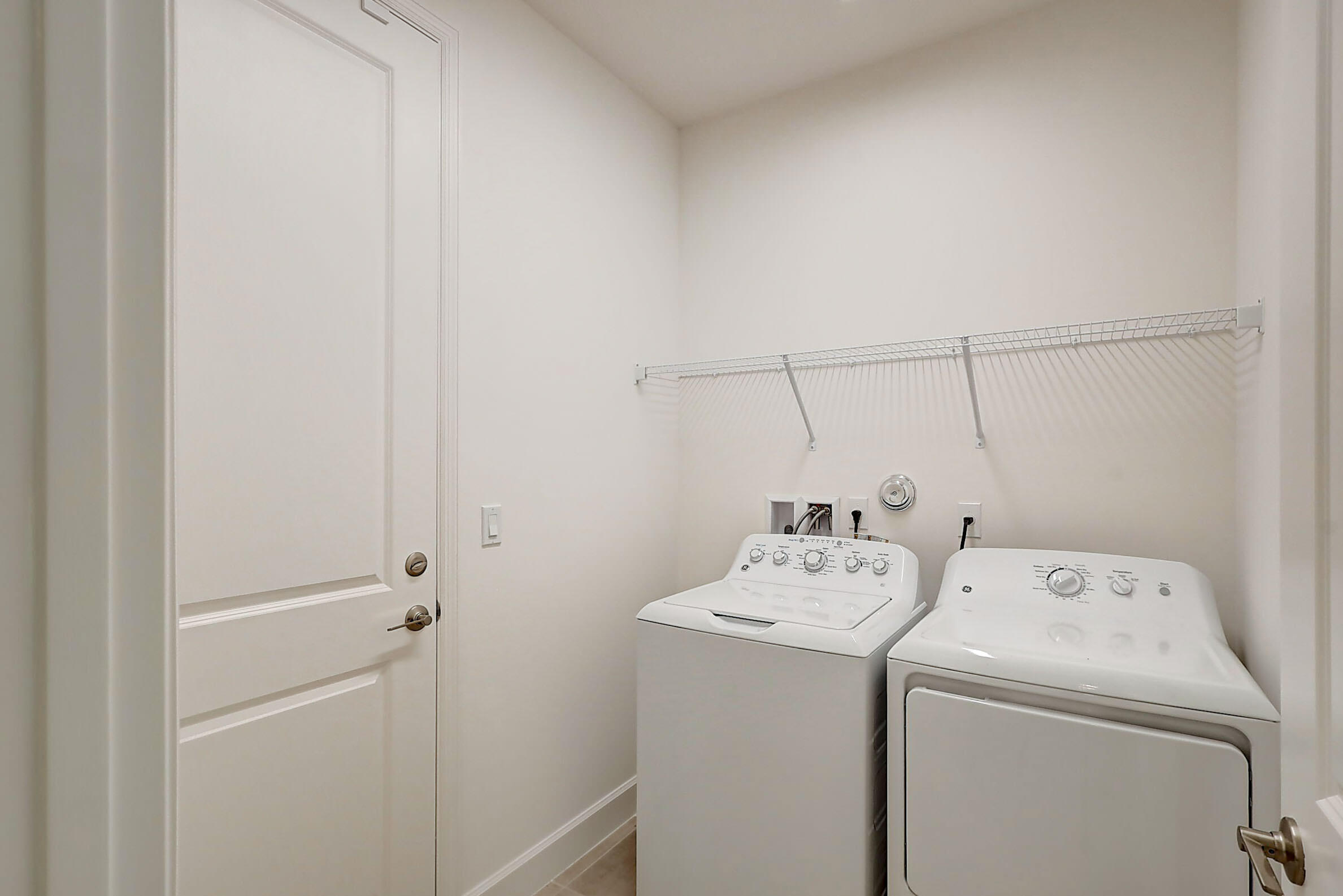13549 Southwest Oceanus Boulevard Port St. Lucie, FL 34987 - Photo 24 of 30 a utility room with dryer and washer