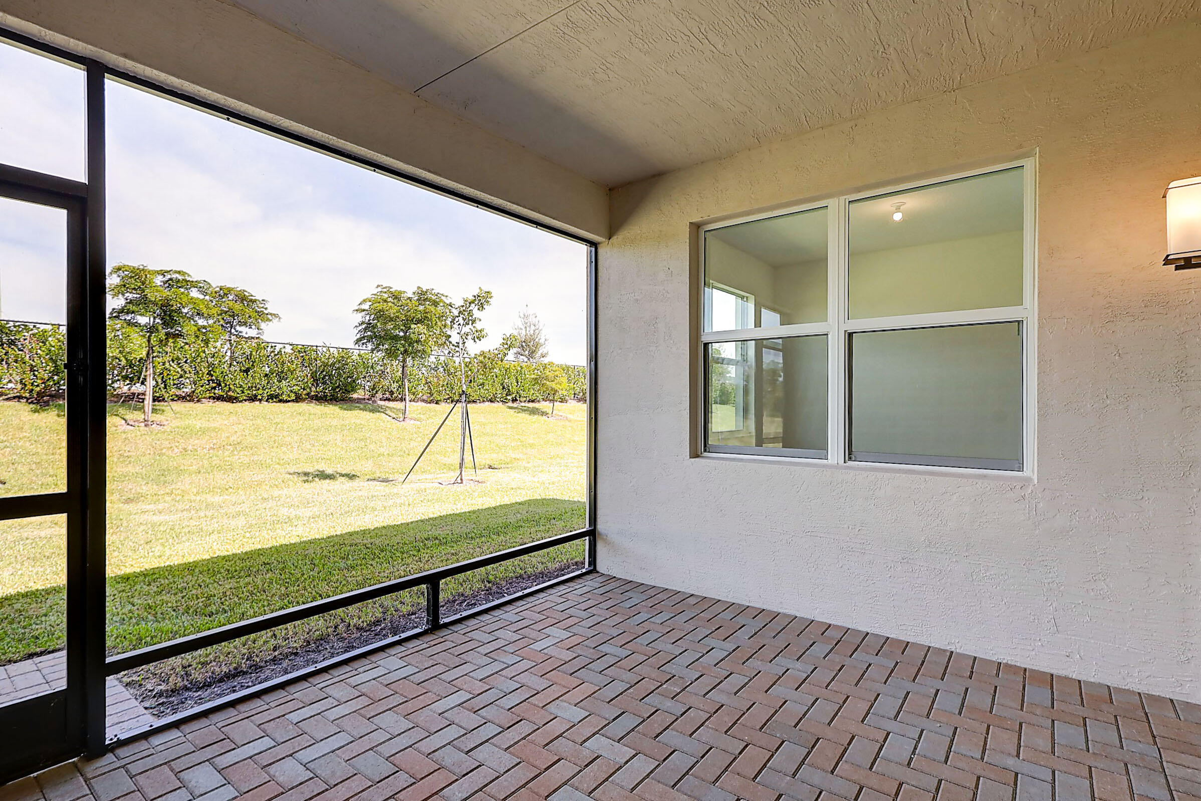 13549 Southwest Oceanus Boulevard Port St. Lucie, FL 34987 - Photo 26 of 30 a view of an empty room with wooden floor and windows
