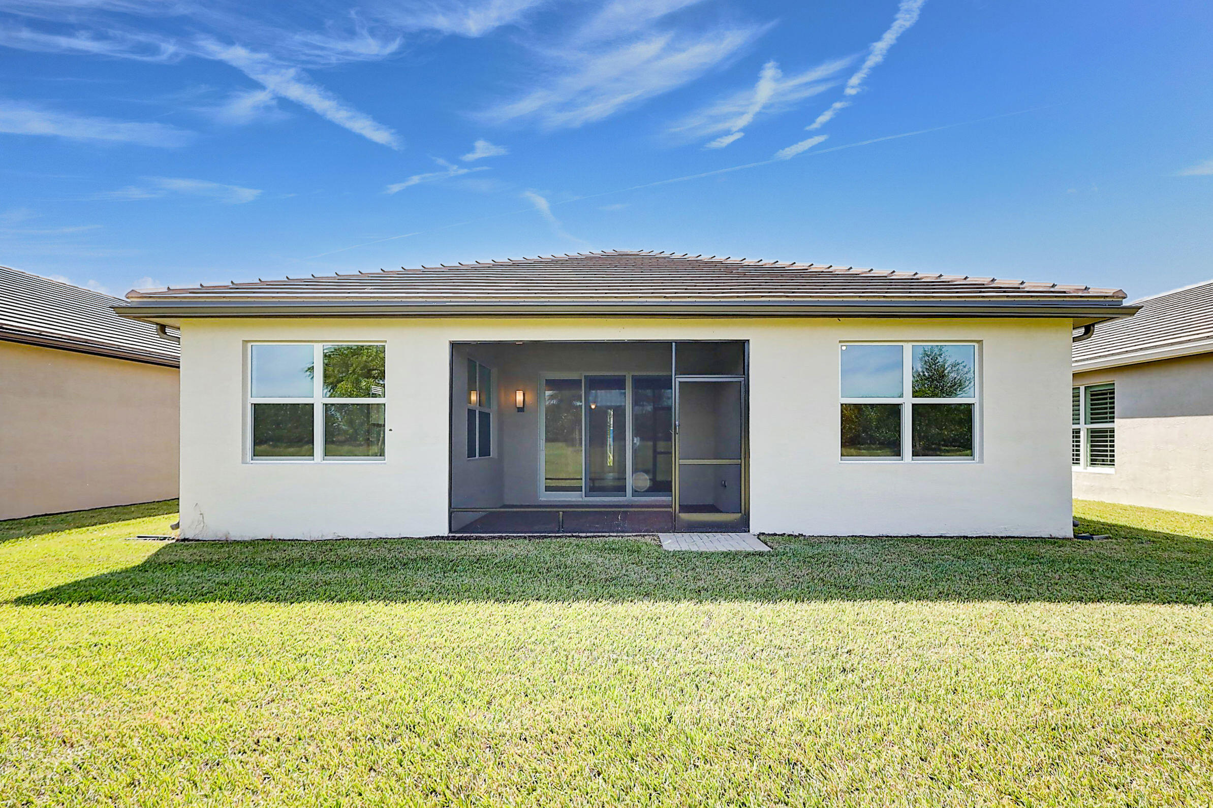 13549 Southwest Oceanus Boulevard Port St. Lucie, FL 34987 - Photo 29 of 30 front view of house with a yard