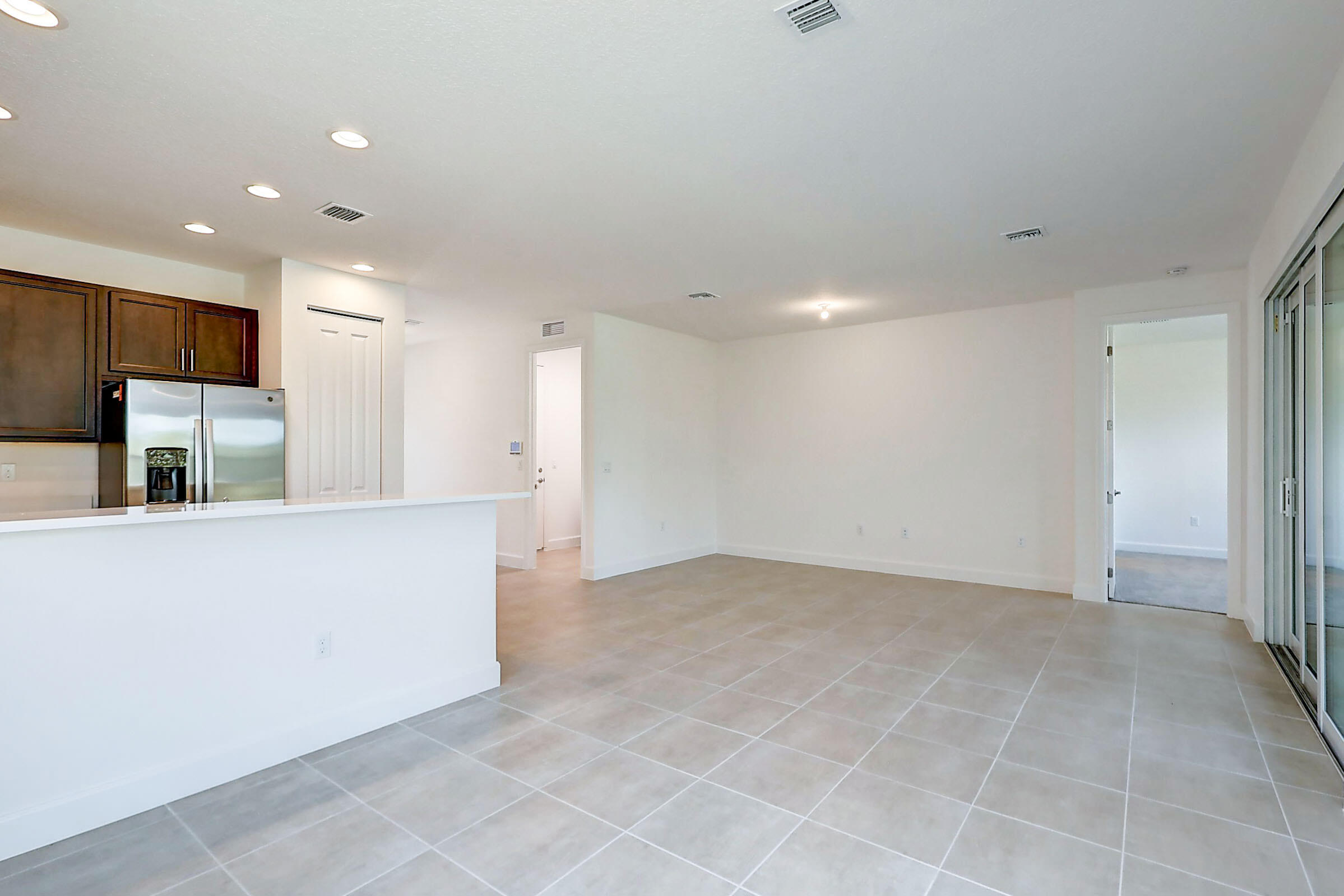 13549 Southwest Oceanus Boulevard Port St. Lucie, FL 34987 - Photo 5 of 30 a view of kitchen with kitchen island and stainless steel appliances