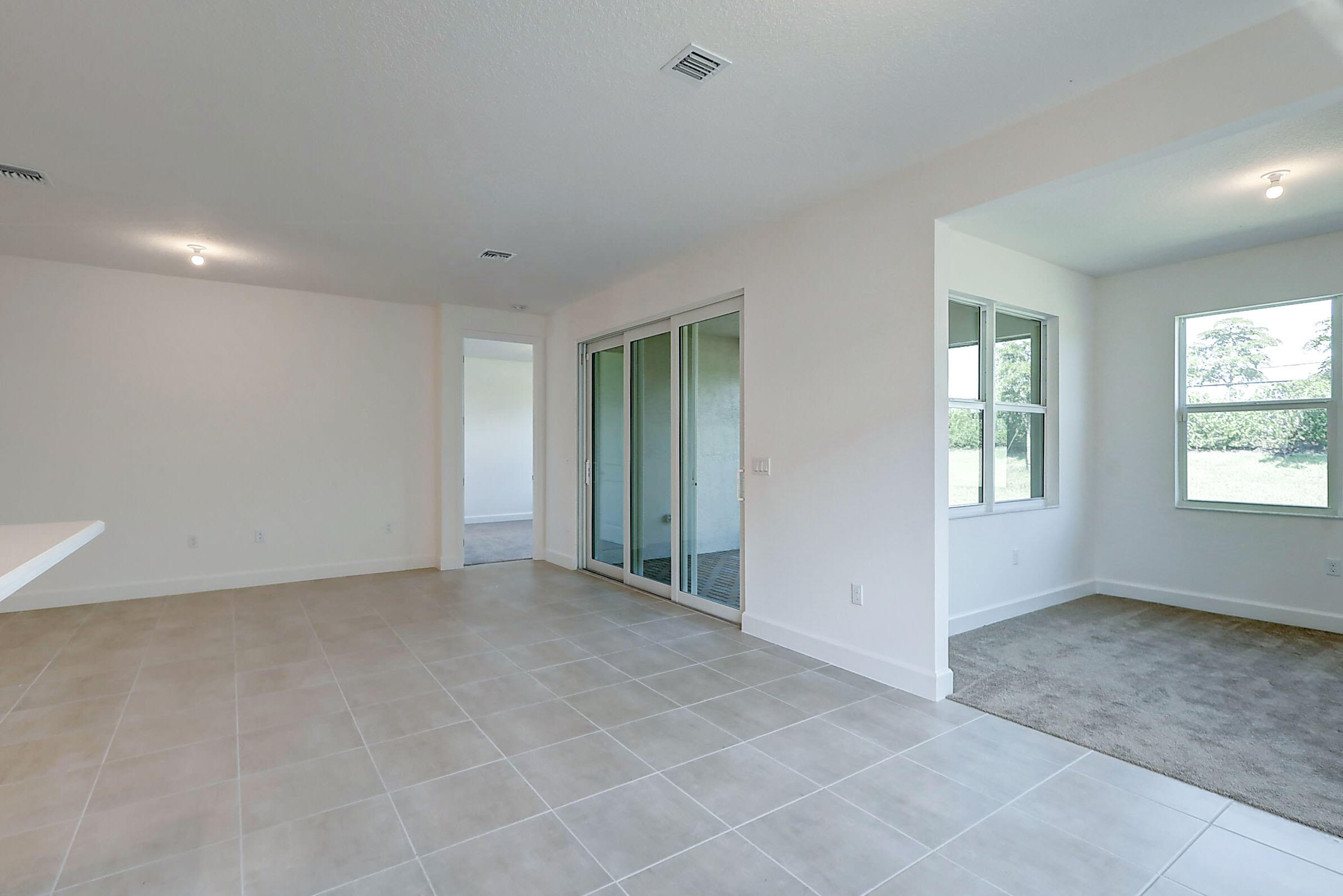 13549 Southwest Oceanus Boulevard Port St. Lucie, FL 34987 - Photo 6 of 30 a view of an empty room with a window