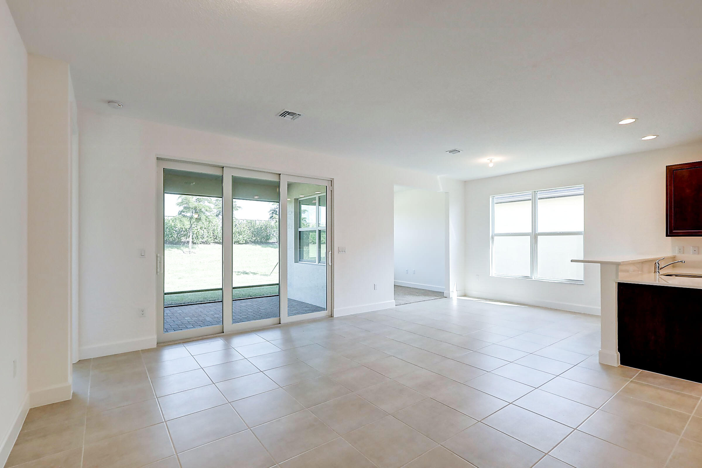 13549 Southwest Oceanus Boulevard Port St. Lucie, FL 34987 - Photo 7 of 30 a view of an empty room with a window