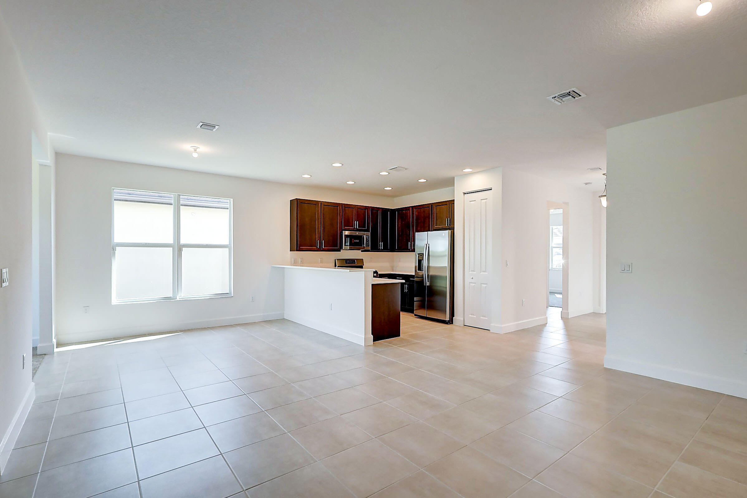 13549 Southwest Oceanus Boulevard Port St. Lucie, FL 34987 - Photo 8 of 30 a view of kitchen with furniture and window