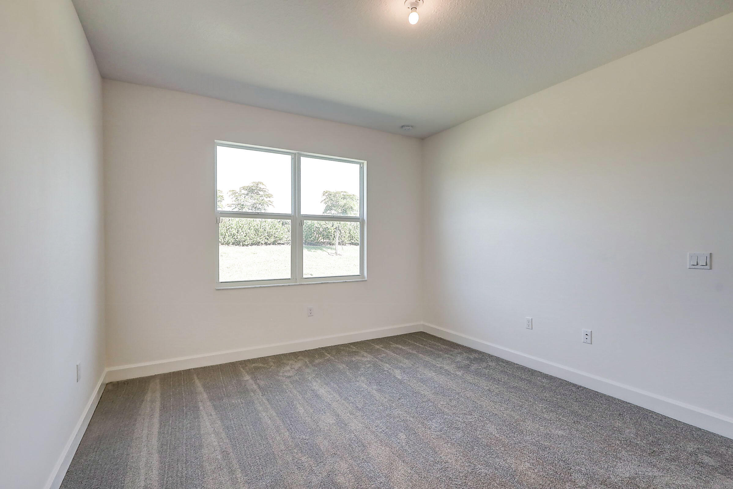 13549 Southwest Oceanus Boulevard Port St. Lucie, FL 34987 - Photo 9 of 30 an empty room with a window