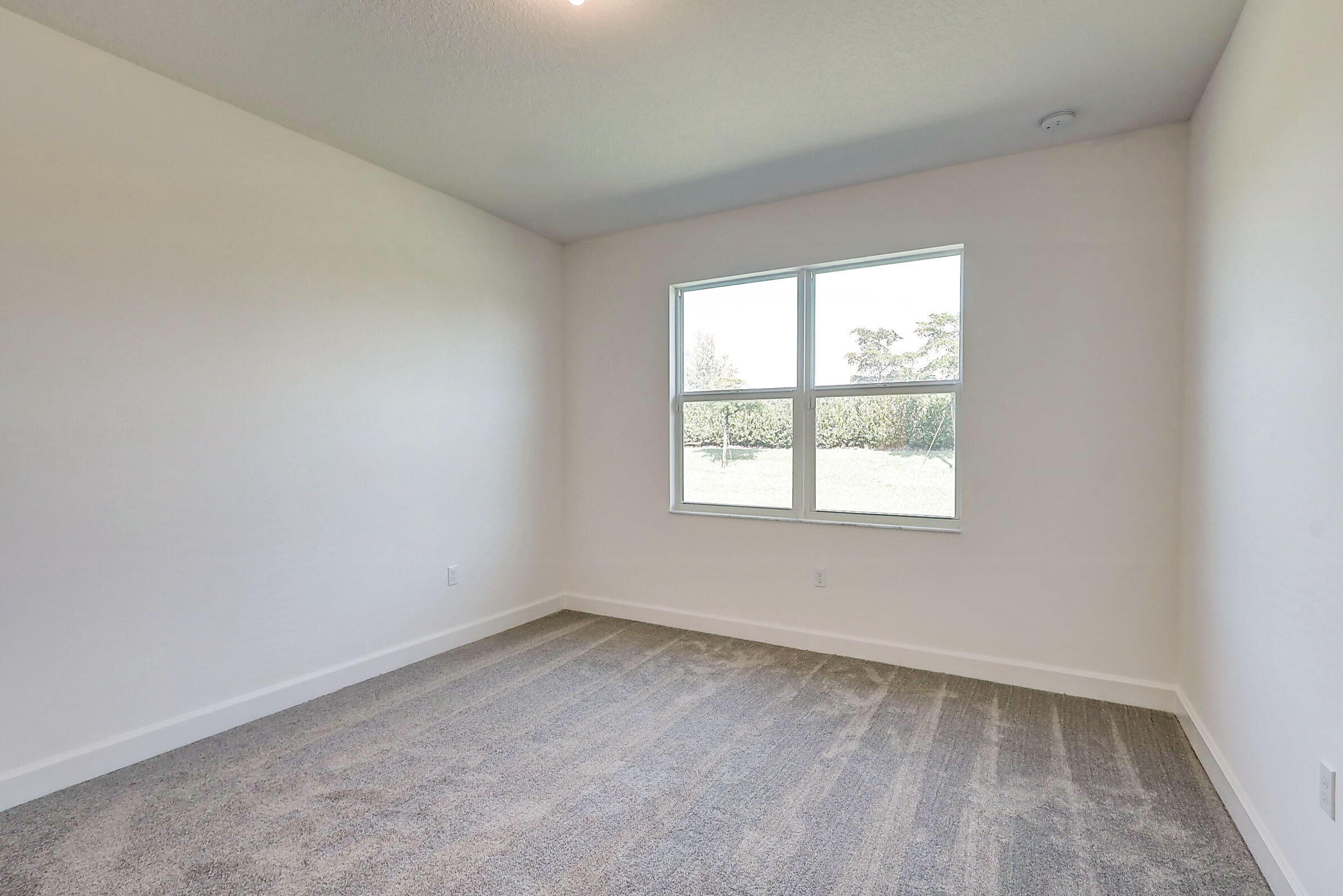 13549 Southwest Oceanus Boulevard Port St. Lucie, FL 34987 - Photo 10 of 30 an empty room with a window