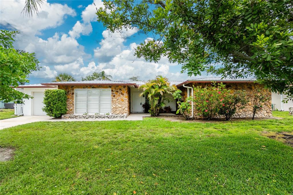 261 Caddy Road Rotonda West, FL 33947 - Photo 1 of 1 a view of a backyard with garden
