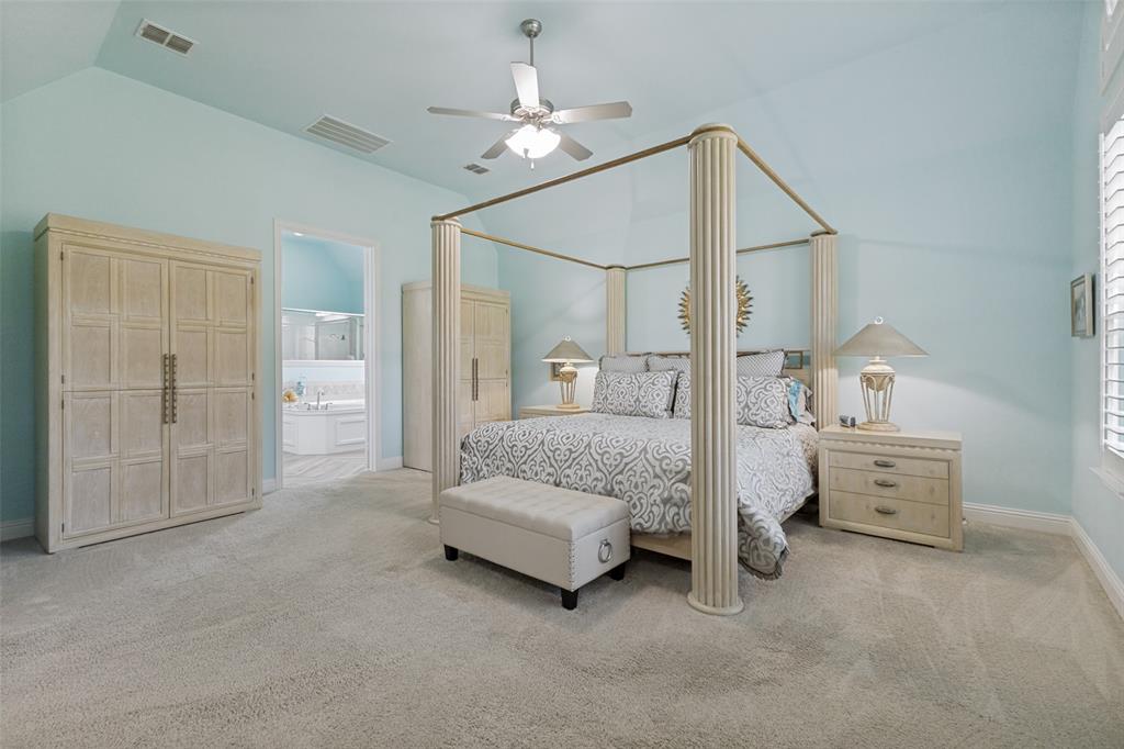 506 Life Spring Drive Rockwall, TX 75087 - Photo 21 of 36 a spacious bedroom with a bed and ceiling fan