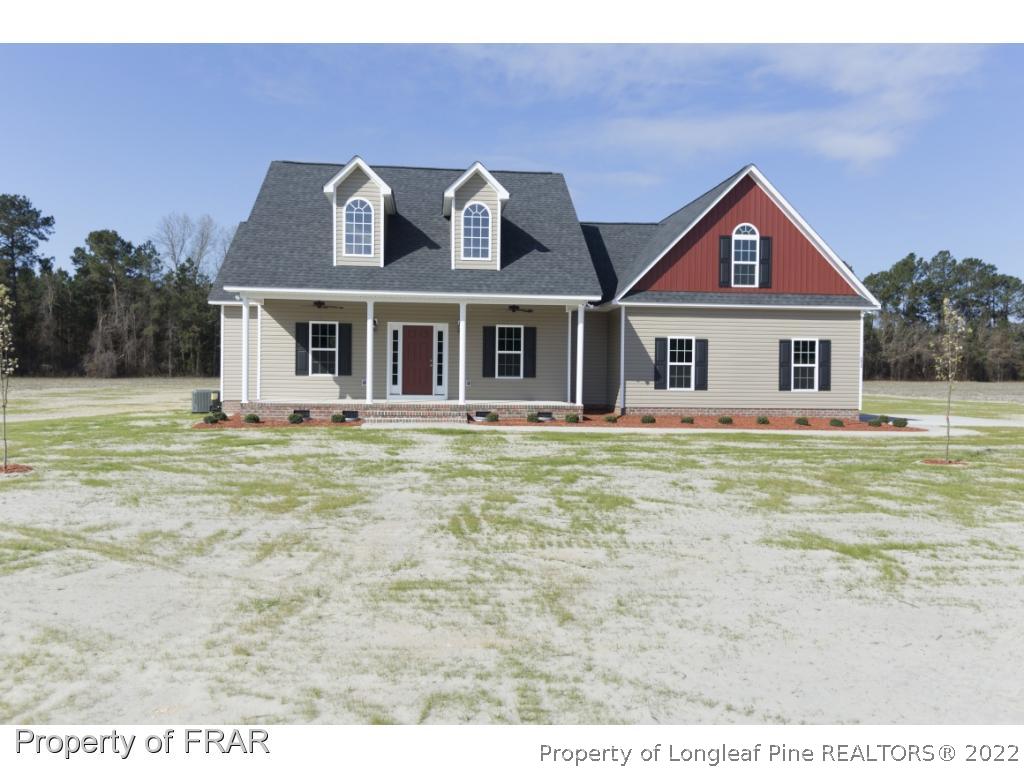 5615 Wade-Stedman Road Wade, NC 28395 - Photo 1 of 36 a front view of a house with garden