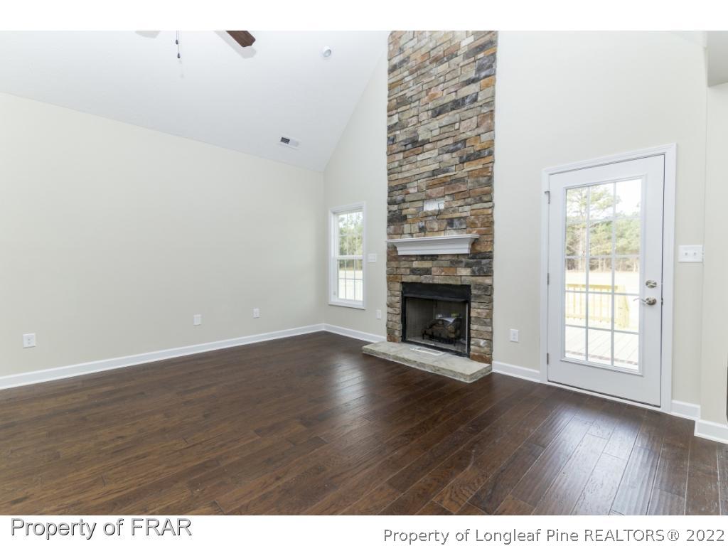 5615 Wade-Stedman Road Wade, NC 28395 - Photo 14 of 36 a view of an empty room with wooden floor and a window