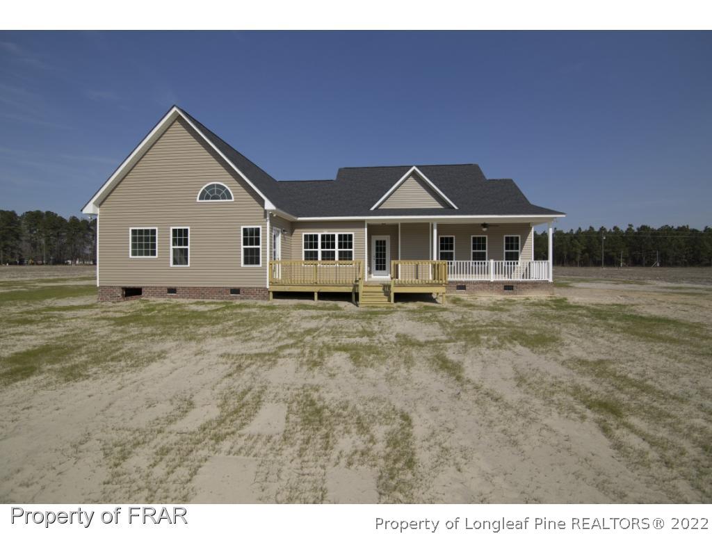 5615 Wade-Stedman Road Wade, NC 28395 - Photo 2 of 36 a front view of a house with a yard