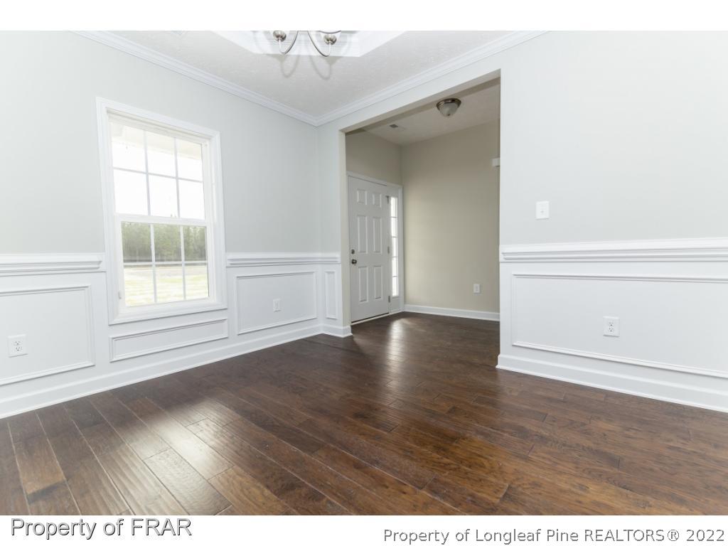 5615 Wade-Stedman Road Wade, NC 28395 - Photo 3 of 36 a view of an empty room with wooden floor and a window