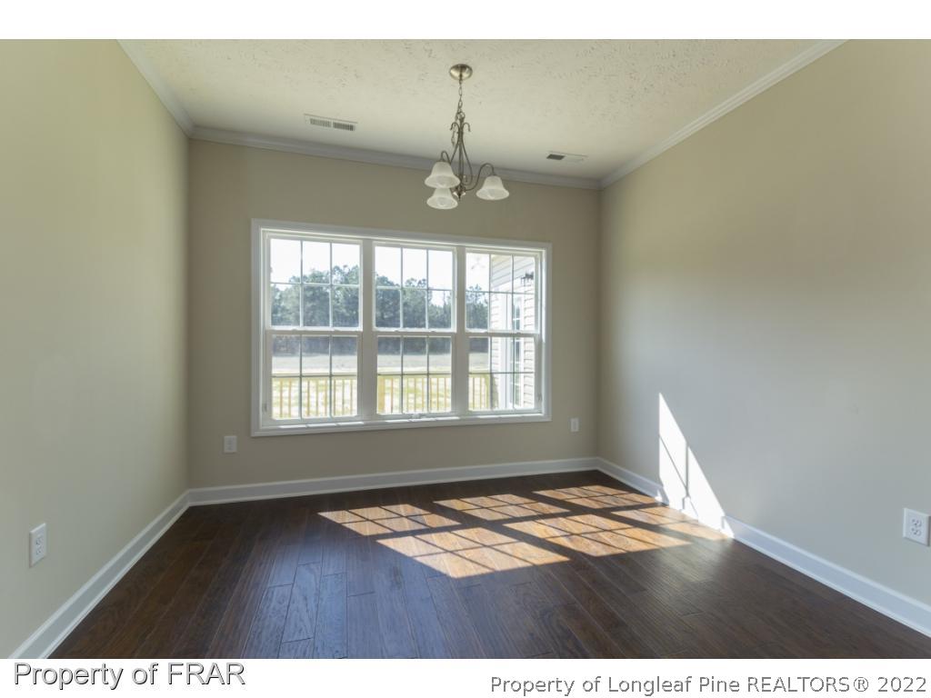 5615 Wade-Stedman Road Wade, NC 28395 - Photo 6 of 36 a view of an empty room with wooden floor and a window