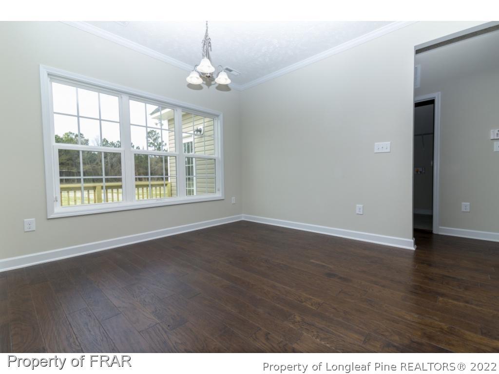 5615 Wade-Stedman Road Wade, NC 28395 - Photo 7 of 36 an empty room with wooden floor and windows