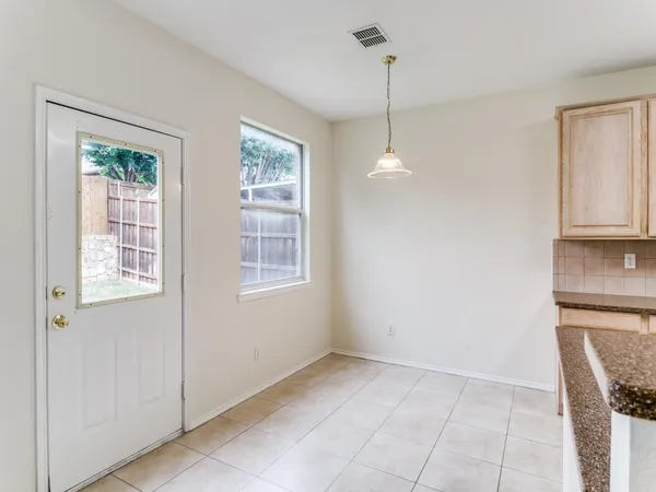 a view of a kitchen with a dishwasher cabinets and a window