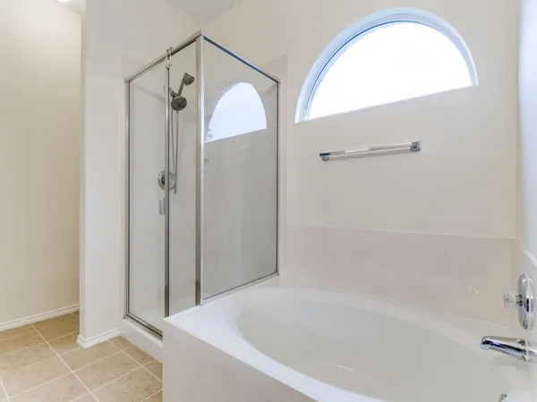 a bathroom with a tub and shower