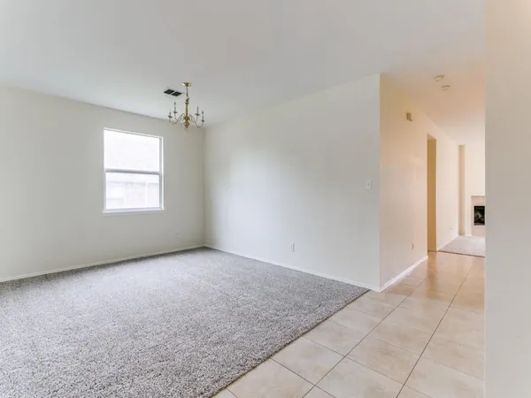 an empty room with windows and entrance